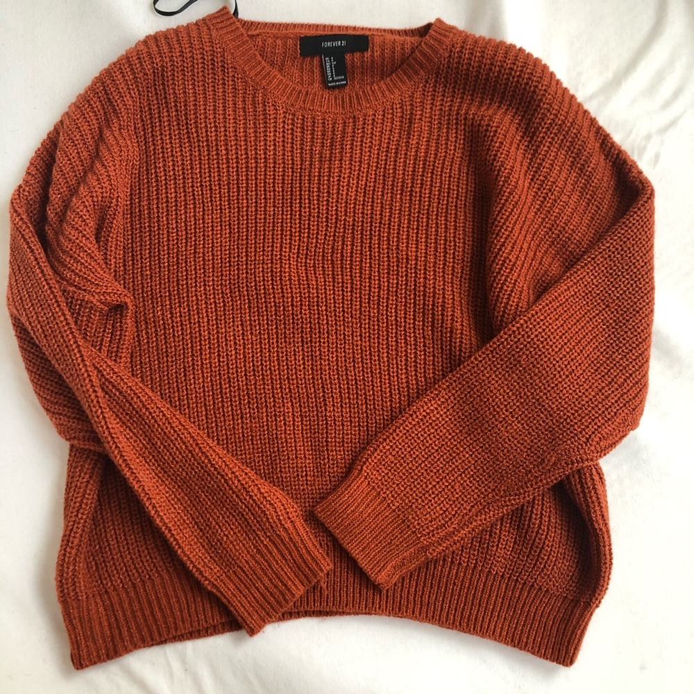 Burnt orange colored knit crew neck sweater